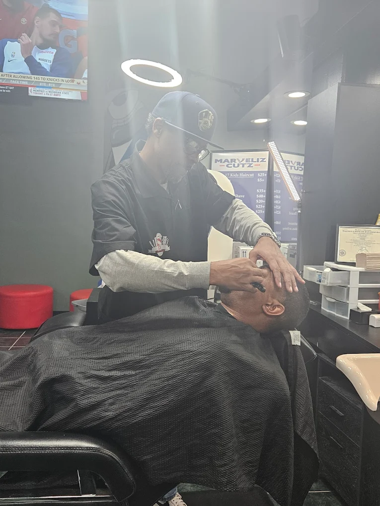Beard shaping and detailing in progress at Marveliz Cutz