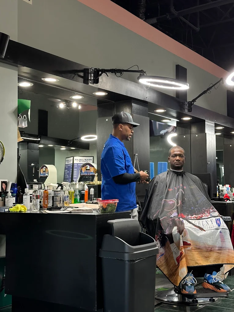 Ron Baggett cutting a client's hair at Marveliz Cutz barbershop in Madison, WI